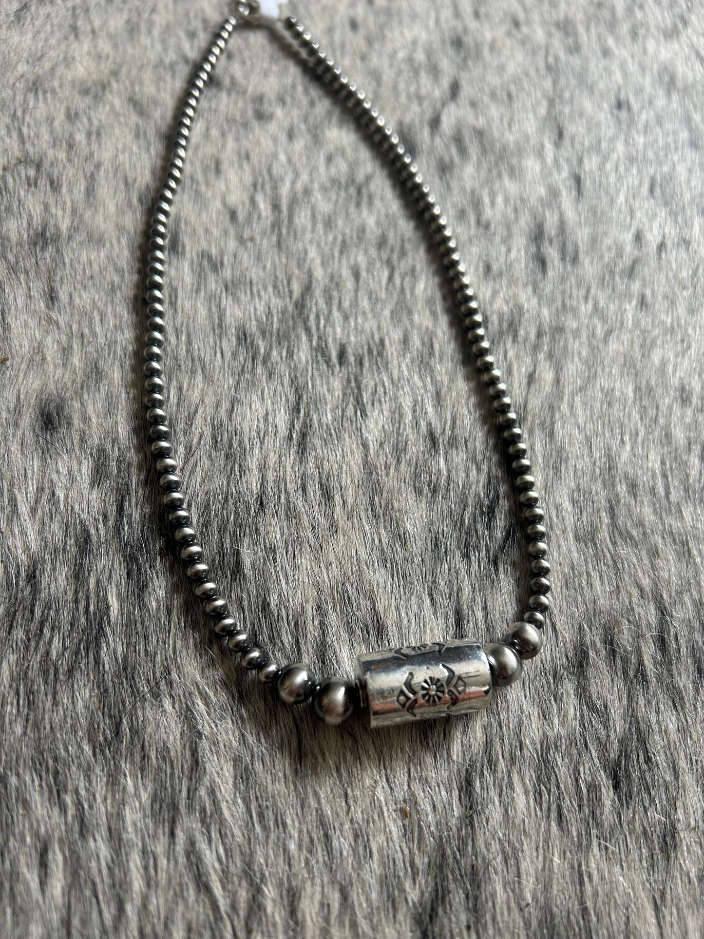 Graduated native pearl stamped shotgun shell necklace