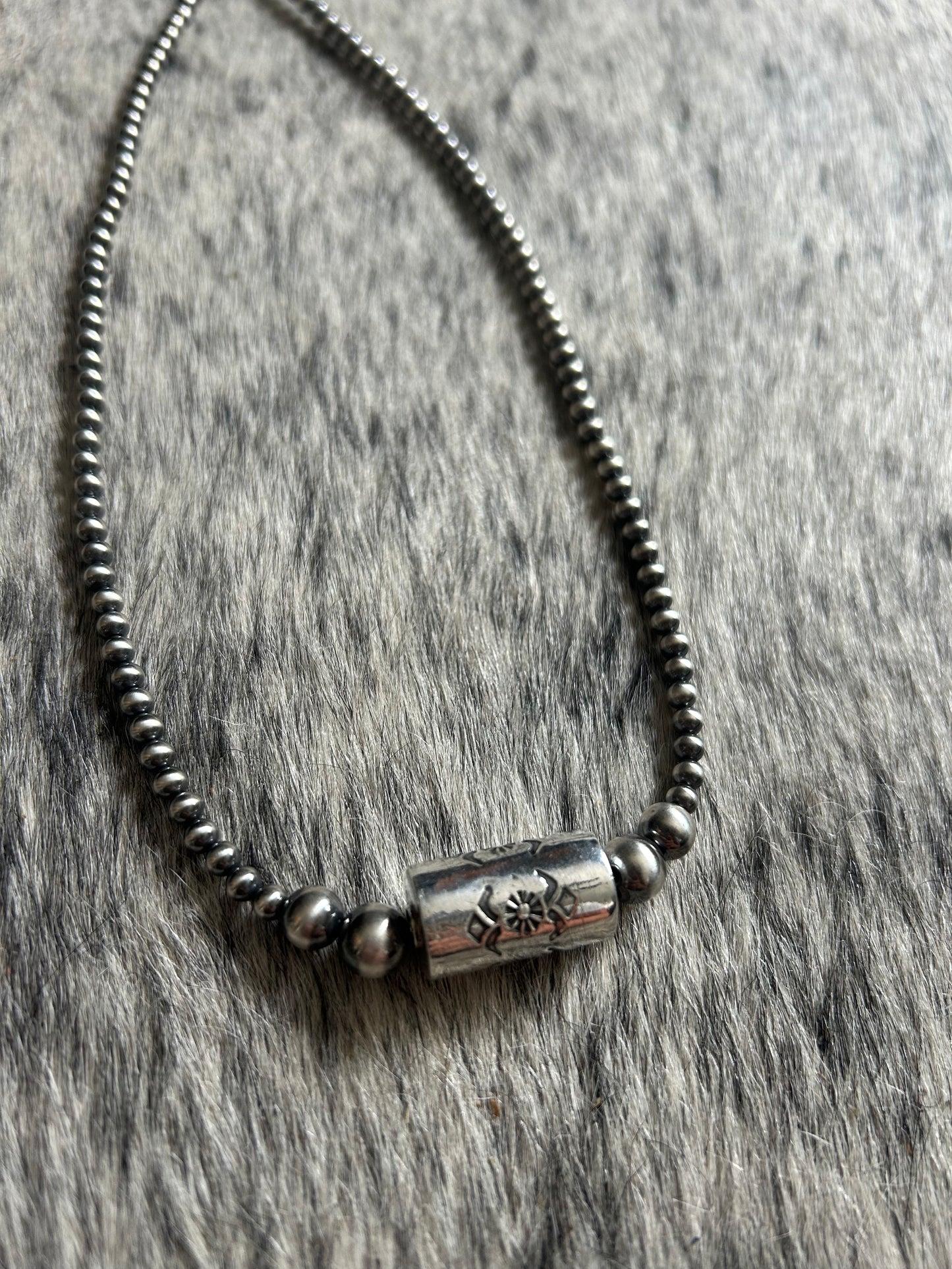 Graduated native pearl stamped shotgun shell necklace